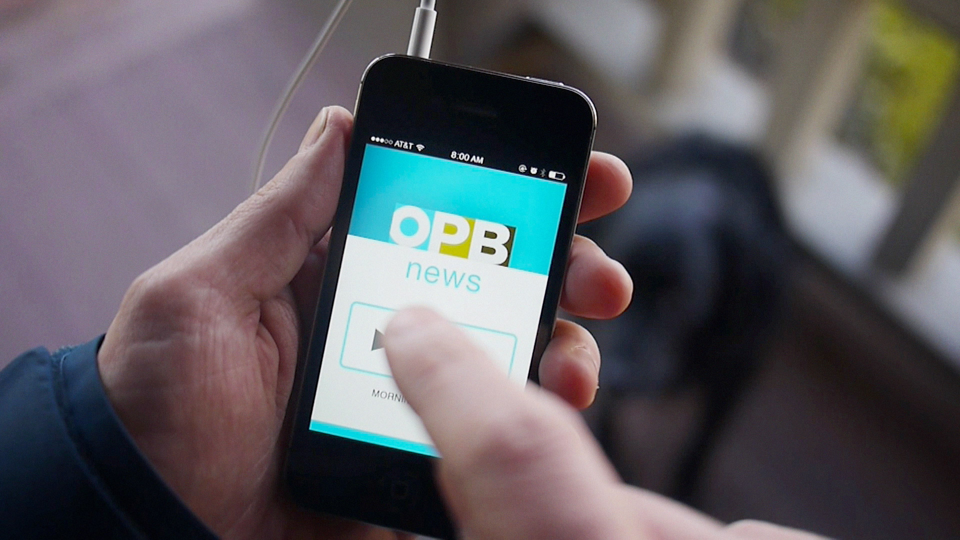 Person listening to OPB radio on mobile device