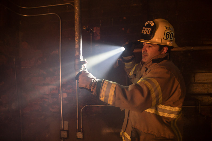 Coast Products photograph of firefighter holding flashlight created by Incubate Design