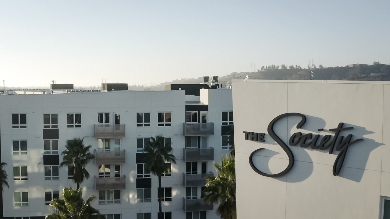 The Society apartments in San Diego photo showing the brand logo on the side of the building created by Incubate Design