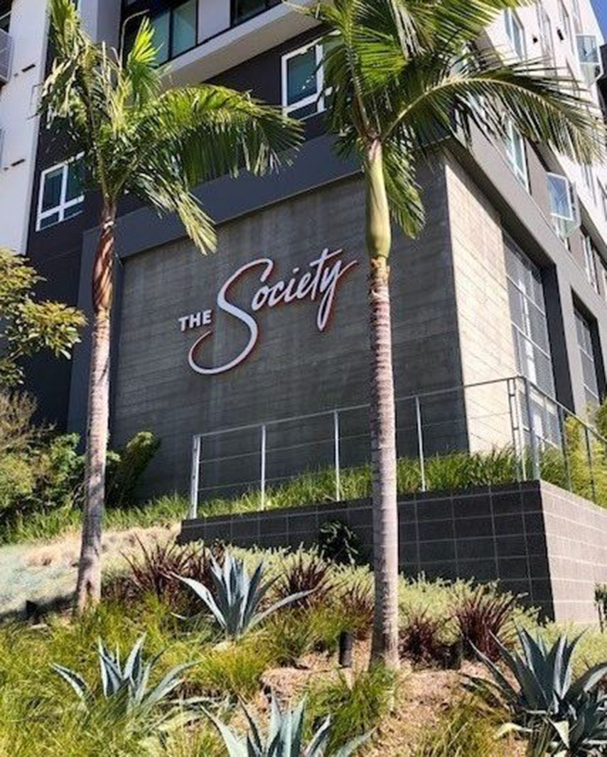 The Society apartments in San Diego photo showing the brand logo on the side of the building created by Incubate Design